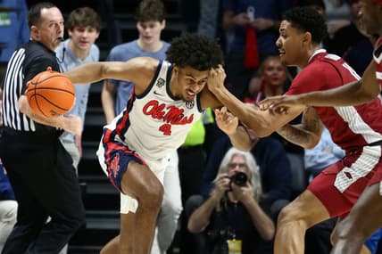 Jan 24, 2024; Oxford, Mississippi, USA; Mississippi Rebels forward Jaemyn Brakefield (4) drives to the basket as Arkansas Razorbacks forward Jalen Graham (11) defends during the first half at The Sandy and John Black Pavilion at Ole Miss. Mandatory Credit: Petre Thomas-USA TODAY Sports