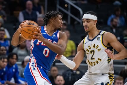 Jan 25, 2024; Indianapolis, Indiana, USA; Philadelphia 76ers guard Tyrese Maxey (0) drives to the basket while Indiana Pacers guard Andrew Nembhard (2) defends in the first half at Gainbridge Fieldhouse. Mandatory Credit: Trevor Ruszkowski-USA TODAY Sports