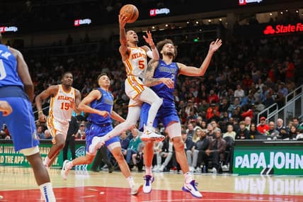 Jan 26, 2024; Atlanta, Georgia, USA; Atlanta Hawks guard Dejounte Murray (5) shoots past Dallas Mavericks center Dereck Lively II (2) in the second half at State Farm Arena. Mandatory Credit: Brett Davis-USA TODAY Sports