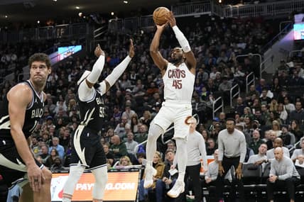 Jan 26, 2024; Milwaukee, Wisconsin, USA;  Cleveland Cavaliers guard Donovan Mitchell (45) shoots against Milwaukee Bucks forward Jae Crowder (99) during the third quarter at Fiserv Forum. Mandatory Credit: Jeff Hanisch-USA TODAY Sports