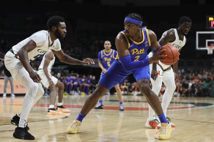 Jan 27, 2024; Coral Gables, Florida, USA; Pittsburgh Panthers forward Blake Hinson (2) protects the basketball from Miami Hurricanes guard Wooga Poplar (5) during the first half at Watsco Center. Mandatory Credit: Sam Navarro-USA TODAY Sports
