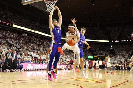 Feb 4, 2023; Ames, Iowa, USA; Iowa State Cyclones guard Tamin Lipsey (3) is trapped by Kansas Jayhawks center Hunter Dickinson (1) and guard Johnny Furphy (10) at James H. Hilton Coliseum. Mandatory Credit: Reese Strickland-USA TODAY Sports