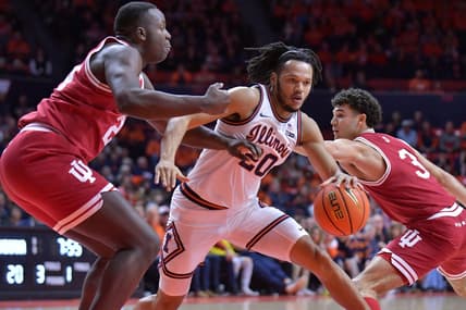 Jan 27, 2024; Champaign, Illinois, USA;  Illinois Fighting Illini forward Ty Rodgers (20) drives the ball between Indiana Hoosiers forward Payton Sparks (24) and guard Anthony Leal (3) during the first half at State Farm Center. Mandatory Credit: Ron Johnson-USA TODAY Sports