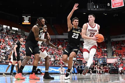 Jan 27, 2024; Pullman, Washington, USA; Washington State Cougars forward Andrej Jakimovski (right) runs the lane against Colorado Buffaloes forward Tristan da Silva (23) in the first half at Friel Court at Beasley Coliseum. Mandatory Credit: James Snook-USA TODAY Sports