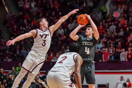 Jan 27, 2024; Blacksburg, Virginia, USA; Georgia Tech Yellow Jackets guard Carter Murphy (4) shoots while being defended by Virginia Tech Hokies guard Sean Pedulla (3) during the first half at Cassell Coliseum. Mandatory Credit: Brian Bishop-USA TODAY Sports