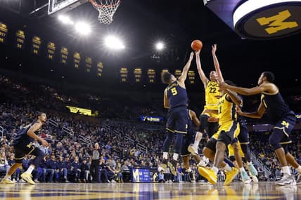Jan 27, 2024; Ann Arbor, Michigan, USA; Iowa Hawkeyes forward Patrick McCaffery (22) shoots on Michigan Wolverines forward Terrance Williams II (5) in the second half at Crisler Center. Mandatory Credit: Rick Osentoski-USA TODAY Sports