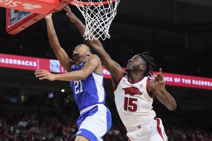 Jan 27, 2024; Fayetteville, Arkansas, USA; Kentucky Wildcats guard D.J. Wagner (21) drives to the basket during the first half as Arkansas Razorbacks forward Makhi Mitchell (15) defends at Bud Walton Arena. Mandatory Credit: Nelson Chenault-USA TODAY Sports