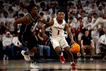 Cincinnati Bearcats guard Day Day Thomas (1) takes the ball up as UCF Knights guard Jaylin Sellers (24) guards him in the first half of the NCAA basketball game between Cincinnati Bearcats and UCF Knights at Fifth Third Arena in Cincinnati on Saturday, Jan. 27, 2024.