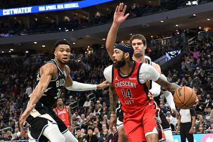 Jan 27, 2024; Milwaukee, Wisconsin, USA; New Orleans Pelicans forward Brandon Ingram (14) dribbles against Milwaukee Bucks forward Giannis Antetokounmpo (34) and Milwaukee Bucks center Brook Lopez (11) in the first half at Fiserv Forum. Mandatory Credit: Michael McLoone-USA TODAY Sports