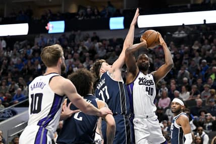 Jan 27, 2024; Dallas, Texas, USA; Sacramento Kings forward Harrison Barnes (40) looks to shoot over Dallas Mavericks guard Luka Doncic (77) during the first quarter at the American Airlines Center. Mandatory Credit: Jerome Miron-USA TODAY Sports