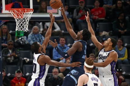 Jan 29, 2024; Memphis, Tennessee, USA; Memphis Grizzlies forward-center Jaren Jackson Jr. (13) shoots between Sacramento Kings forward Harrison Barnes (40)and Sacramento Kings forward Keegan Murray (13) during the first half at FedExForum. Mandatory Credit: Petre Thomas-USA TODAY Sports
