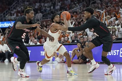 Jan 29, 2024; Austin, Texas, USA; Texas Longhorns guard Tyrese Hunter (4) drives to the basket between Houston Cougars forward Ja'Vier Francis (5) and guard Mylik Wilson (8) during the first half at Moody Center. Mandatory Credit: Scott Wachter-USA TODAY Sports