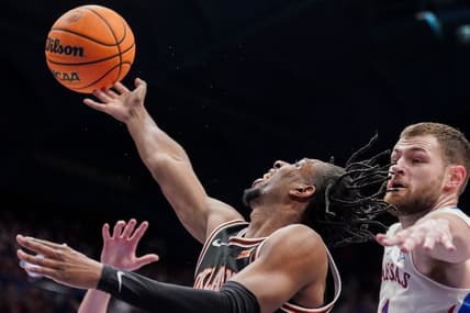 Jan 30, 2024; Lawrence, Kansas, USA; Oklahoma State Cowboys guard Jarius Hicklen (4) shoots as Kansas Jayhawks center Hunter Dickinson (1) defends during the first half at Allen Fieldhouse. Mandatory Credit: Denny Medley-USA TODAY Sports