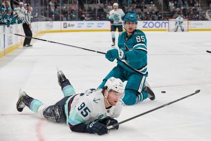 Jan 30, 2024; San Jose, California, USA; San Jose Sharks defenseman Shakir Mukhamadullin (85) and Seattle Kraken left wing Andre Burakovsky (95) after a penalty is called against Mukhamadullin during the first period at SAP Center at San Jose. Mandatory Credit: Robert Edwards-USA TODAY Sports