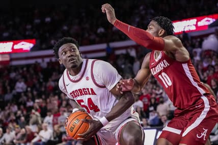Jan 31, 2024; Athens, Georgia, USA; Georgia Bulldogs center Russel Tchewa (54) looks for a shot against Alabama Crimson Tide forward Mouhamed Dioubate (10) during the first half at Stegeman Coliseum. Mandatory Credit: Dale Zanine-USA TODAY Sports