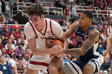 Dec 31, 2023; Stanford, California, USA; Stanford Cardinal forward Maxime Raynaud (42) and Arizona Wildcats forward Keshad Johnson (16) fight for control of the ball during the second half at Maples Pavilion. Mandatory Credit: Stan Szeto-USA TODAY Sports