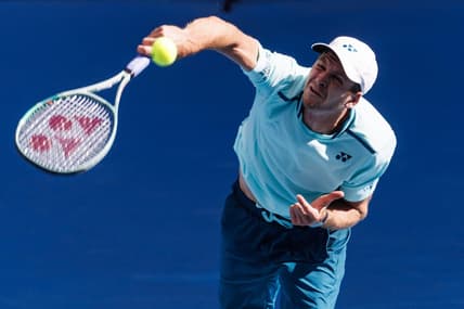 Jan 24, 2024; Melbourne, Victoria, Australia;  Hubert Hurkacz of Poland in action against Daniil Medvedev of Russia in the quarter final of the men   s singles at the Australian Open.Mandatory Credit: Mike Frey-USA TODAY Sports