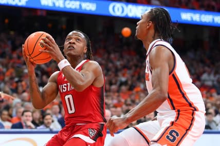 Jan 27, 2024; Syracuse, New York, USA; North Carolina State Wolfpack guard DJ Horne (0) drives as Syracuse Orange guard JJ Starling (2) defends during the first half at the JMA Wireless Dome. Mandatory Credit: Rich Barnes-USA TODAY Sports