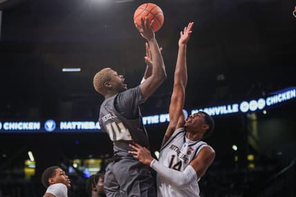 Jan 9, 2024; Atlanta, Georgia, USA; Georgia Tech Yellow Jackets guard Kowacie Reeves Jr. (14) shoots over Notre Dame Fighting Irish forward Kebba Njie (14) in the second half at McCamish Pavilion. Mandatory Credit: Brett Davis-USA TODAY Sports