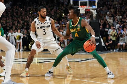 Jan 31, 2024; Orlando, Florida, USA; UCF Knights guard Darius Johnson (3) defends Baylor Bears guard Ja'Kobe Walter (4) during the first half at Addition Financial Arena. Mandatory Credit: Mike Watters-USA TODAY Sports