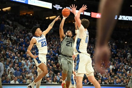 Feb 2, 2024; Omaha, Nebraska, USA; Butler Bulldogs guard Pierre Brooks (21) shoots over Creighton Bluejays guard Trey Alexander (23) and center Ryan Kalkbrenner (11) in the first half at CHI Health Center Omaha. Mandatory Credit: Steven Branscombe-USA TODAY Sports