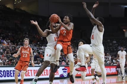 Feb 3, 2024; Coral Gables, Florida, USA; Virginia Tech Hokies guard MJ Collins (2) drives to the basket against Miami Hurricanes forward Norchad Omier (15) during the first half at Watsco Center. Mandatory Credit: Sam Navarro-USA TODAY Sports