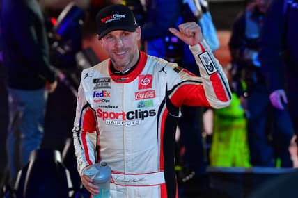 Feb 3, 2024; Los Angeles, California, USA;  NASCAR Cup Series driver Denny Hamlin (11) celebrates his victory of the Busch Light Clash at Los Angeles Memorial Coliseum. Mandatory Credit: Gary A. Vasquez-USA TODAY Sports