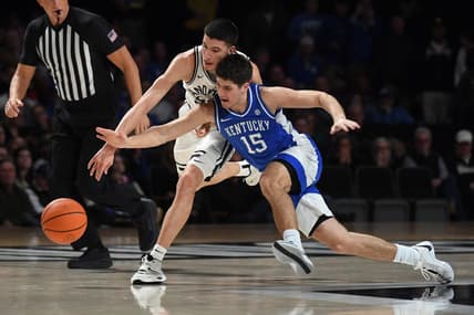 Feb 6, 2024; Nashville, Tennessee, USA; Vanderbilt Commodores guard Jason Rivera-Torres (23) and Kentucky Wildcats guard Reed Sheppard (15) battle for a loose ball during the first half at Memorial Gymnasium. Mandatory Credit: Christopher Hanewinckel-USA TODAY Sports