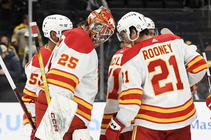 Feb 6, 2024; Boston, Massachusetts, USA; Calgary Flames goaltender Jacob Markstrom (25) and center Kevin Rooney (21) butt heads after defeating the Boston Bruins at TD Garden. Mandatory Credit: Bob DeChiara-USA TODAY Sports