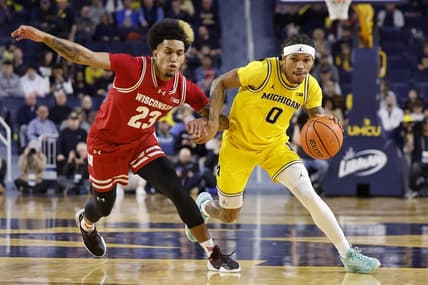 Feb 7, 2024; Ann Arbor, Michigan, USA;  Michigan Wolverines guard Dug McDaniel (0) dnr on Wisconsin Badgers guard Chucky Hepburn (23) in the first half at Crisler Center. Mandatory Credit: Rick Osentoski-USA TODAY Sports