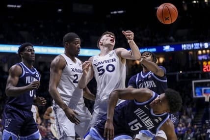 Feb 7, 2024; Cincinnati, Ohio, USA; Xavier Musketeers forward Gytis Nemeiksa (50) battles for the ball against Villanova Wildcats guard Jordan Longino (15) in the first half at Cintas Center. Mandatory Credit: Katie Stratman-USA TODAY Sports