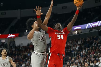 Feb 7, 2024; Starkville, Mississippi, USA; Georgia Bulldogs center Russel Tchewa (54) shoots as Mississippi State Bulldogs forward Tolu Smith (1) defends during the first half at Humphrey Coliseum. Mandatory Credit: Petre Thomas-USA TODAY Sports