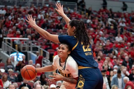 Louisville Cardinals forward Nyla Harris (2) attempts to get around Notre Dame Fighting Irish forward Kylee Watson (22) for a layup during their game on Thursday, Feb. 8, 2024 at KFC YUM Center.