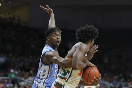 Feb 10, 2024; Coral Gables, Florida, USA; North Carolina Tar Heels forward Harrison Ingram (55) reacts as he guards Miami Hurricanes forward Norchad Omier (15) during the first half at Watsco Center. Mandatory Credit: Sam Navarro-USA TODAY Sports