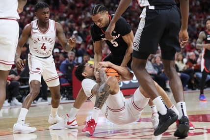 Feb 10, 2024; Fayetteville, Arkansas, USA; Arkansas Razorbacks forward Jalen Graham (11) and Georgia Bulldogs center Frank Anselem-Ibe (5) wrestle for possession during the first half at Bud Walton Arena. Mandatory Credit: Nelson Chenault-USA TODAY Sports