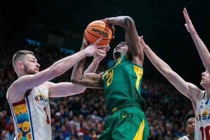 Feb 10, 2024; Lawrence, Kansas, USA; Baylor Bears center Yves Missi (21) gets tangled up with Kansas Jayhawks center Hunter Dickinson (1) under the basket during the first half at Allen Fieldhouse. Mandatory Credit: William Purnell-USA TODAY Sports
