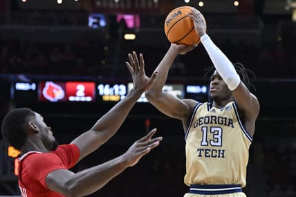 Feb 10, 2024; Louisville, Kentucky, USA; Georgia Tech Yellow Jackets guard Miles Kelly (13) shoots against Louisville Cardinals forward Brandon Huntley-Hatfield (5) during the first half at KFC Yum! Center. Mandatory Credit: Jamie Rhodes-USA TODAY Sports