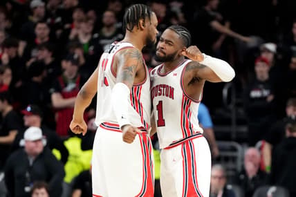 Houston Cougars forward J'Wan Roberts (13) and Houston Cougars guard Jamal Shead (1) celebrate the win at the conclusion of the second half of an NCAA college basketball game against the Cincinnati Bearcats, Saturday, Feb. 10, 2024, at Fifth Third Arena in Cincinnati.