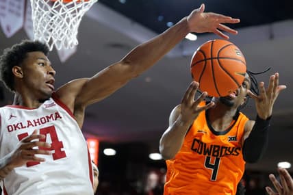 Oklahoma Sooners forward Jalon Moore (14) reaches for the ball beside Oklahoma State Cowboys guard Jarius Hicklen (4) during a Bedlam college basketball game between the University of Oklahoma Sooners (OU) and the Oklahoma State Cowboys (OSU) at Lloyd Noble Center in Norman, Okla., Saturday, Feb. 10, 2024.