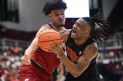 Feb 10, 2024; Stanford, California, USA; Stanford Cardinal forward Spencer Jones (14) defends against USC Trojans guard Isaiah Collier (1) during the first half at Maples Pavilion. Mandatory Credit: Robert Edwards-USA TODAY Sports