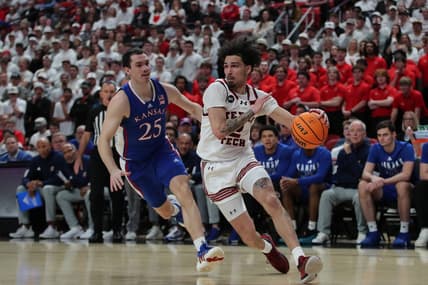 Feb 12, 2024; Lubbock, Texas, USA;  Texas Tech Red Raiders guard Pop Isaacs (2) drives to the lane against Kansas Jayhawks guard Nicolas Timberlake (25) in the first half at United Supermarkets Arena. Mandatory Credit: Michael C. Johnson-USA TODAY Sports