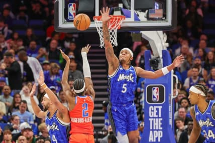 Feb 13, 2024; Orlando, Florida, USA; Oklahoma City Thunder guard Shai Gilgeous-Alexander (2) shoots the ball over Orlando Magic forward Paolo Banchero (5) during the first quarter at Amway Center. Mandatory Credit: Mike Watters-USA TODAY Sports