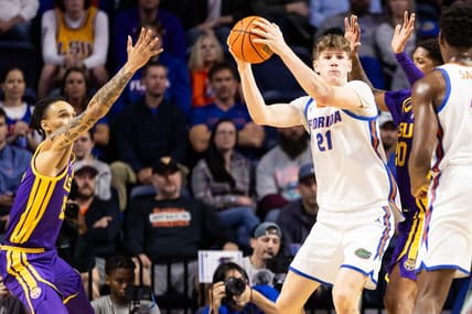 Feb 13, 2024; Gainesville, Florida, USA; Florida Gators forward Alex Condon (21) looks to pass away from LSU Tigers forward Tyrell Ward (15) and LSU Tigers forward Derek Fountain (20) during the first half at Exactech Arena at the Stephen C. O'Connell Center. Mandatory Credit: Matt Pendleton-USA TODAY Sports