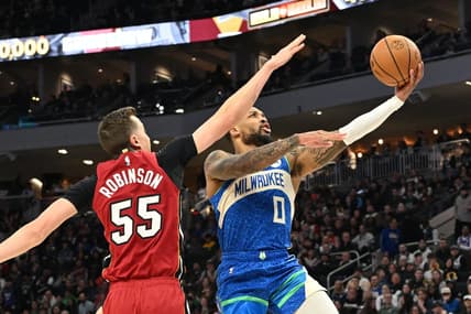 Feb 13, 2024; Milwaukee, Wisconsin, USA; Milwaukee Bucks guard Damian Lillard (0) drives to the basket against Miami Heat forward Duncan Robinson (55) in the first half at Fiserv Forum. Mandatory Credit: Michael McLoone-USA TODAY Sports