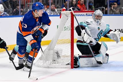 Feb 13, 2024; Elmont, New York, USA; New York Islanders center Mathew Barzal (13) attempts. A pass behind Seattle Kraken goaltender Philipp Grubauer (31) during the second period at UBS Arena. Mandatory Credit: Dennis Schneidler-USA TODAY Sports