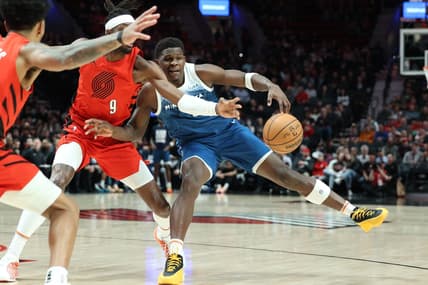 Feb 13, 2024; Portland, Oregon, USA; Minnesota Timberwolves guard Anthony Edwards (5) fights for possession against Portland Trail Blazers forward Jerami Grant (9) in the first quarter at Moda Center. Mandatory Credit: Jaime Valdez-USA TODAY Sports