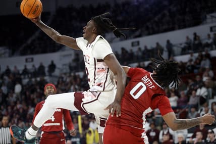 Feb 17, 2024; Starkville, Mississippi, USA; Mississippi State Bulldogs forward KeShawn Murphy (12) collects a rebound over Arkansas Razorbacks guard Khalif Battle (0) during the first half at Humphrey Coliseum. Mandatory Credit: Petre Thomas-USA TODAY Sports