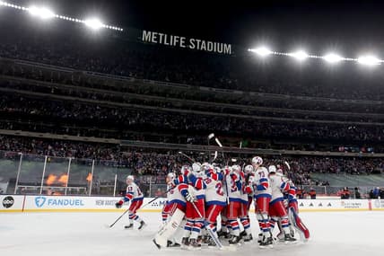 Feb 18, 2024; East Rutherford, New Jersey, USA; New York Rangers players celebrate after defeating the New York Islanders during the overtime period of a Stadium Series ice hockey game at MetLife Stadium. Mandatory Credit: Brad Penner-USA TODAY Sports