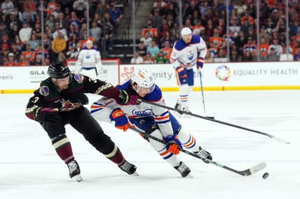 Feb 19, 2024; Tempe, Arizona, USA; Arizona Coyotes defenseman Josh Brown (3) checks Edmonton Oilers center Ryan McLeod (71) during the second period at Mullett Arena. Mandatory Credit: Joe Camporeale-USA TODAY Sports