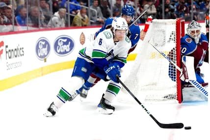 Feb 20, 2024; Denver, Colorado, USA; Vancouver Canucks right wing Brock Boeser (6) skates past Colorado Avalanche defenseman Devon Toews (7) in the third period at Ball Arena. Mandatory Credit: Ron Chenoy-USA TODAY Sports